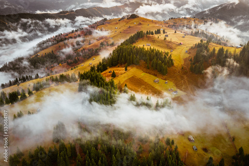 Romania landscape on a foggy autumn morning in Fundata, Brasov on the Rucar Bran pass photo