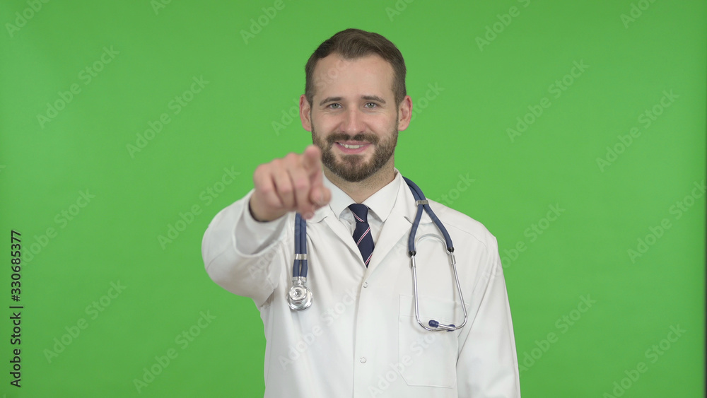The Cheerful Doctor Pointing Finger and Inviting against Chroma Key The Cheerful Doctor Pointing Finger and Inviting against Chroma Key