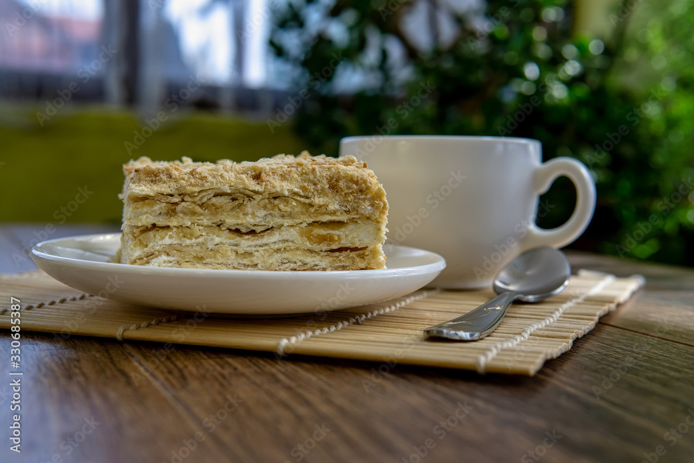 Cup of tea with cake on brown table background Cup of tea with cake on brown table background