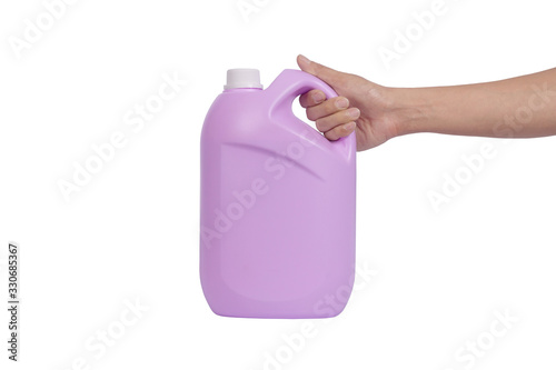 Hand holding Laundry detergent gallon isolated on white background.
