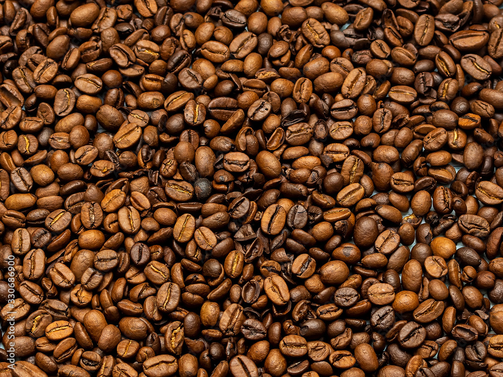 roasted coffee beans, a mixture of arabica and robusta, completely filling the frame