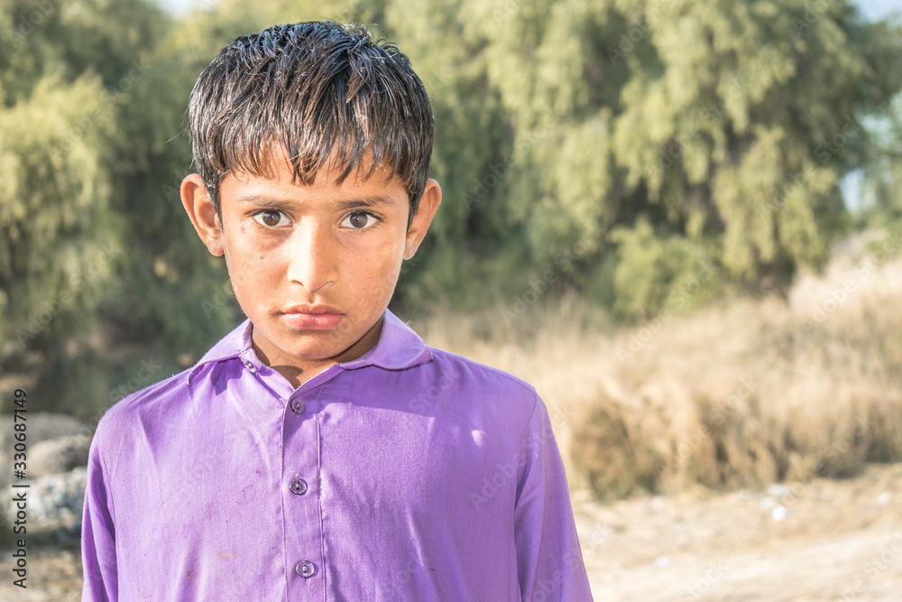 closeup of a poor staring hungry orphan boy in a refugee camp with sad expression on his face and his face and clothes are dirty and his eyes are full of pain closeup of a poor staring hungry orphan boy in a refugee camp with sad expression on his face and his face and clothes are dirty and his eyes are full of pain