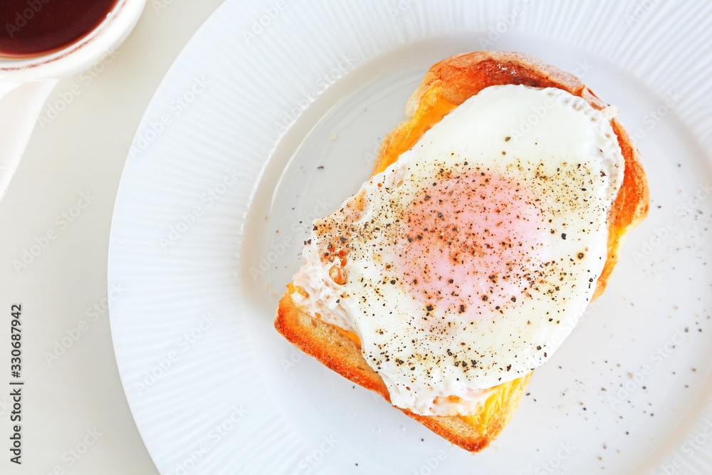 Close up of egg cheese toast on simple white plate Close up of egg cheese toast on simple white plate
