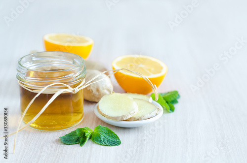 honey, lemon, ginger root on light wooden background with copy space. prevention and treatment of colds