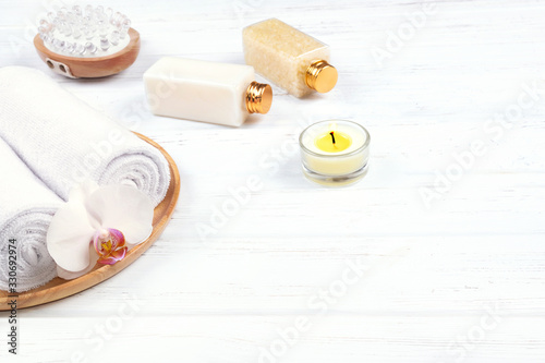 Composition of different spa, beauty and wellness products on white wooden background.