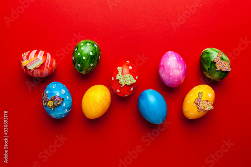 Bright easter eggs with bunny  rabbit  on red background. Retro colorful spring decoration.