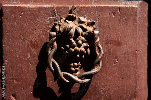 Montemerano (GR), Italy - September 11, 2017: An old knocker on a door in Montemerano village, Manciano, Grosseto, Tuscany, Italy, Europe