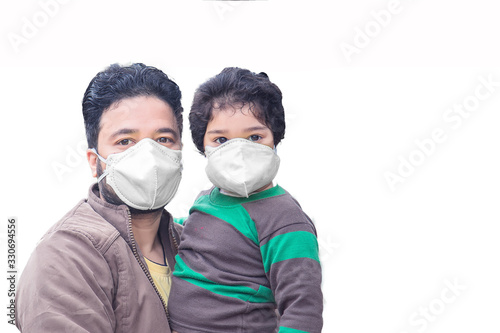 Father and child wear facemask during coronavirus and flu outbreak on white background. Virus and illness protection