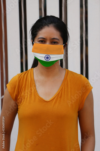 India flag on hygienic mask. Masked Asian woman prevent germs. concept of Tiny Particle protection or Covid 19.