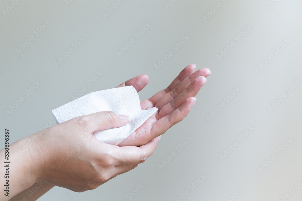 Woman cleaning her hands with white soft tissue paper. isolated on a white backgrounds Woman cleaning her hands with white soft tissue paper. isolated on a white backgrounds