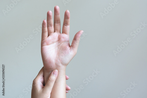 Woman massaging her painful hand. Healthcare and medical concept.