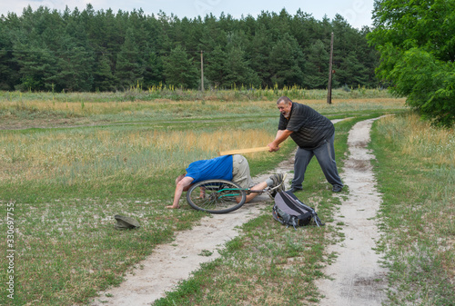 Senior man punishing thief who driven away his ancient bicycle in Ukrainian rural area