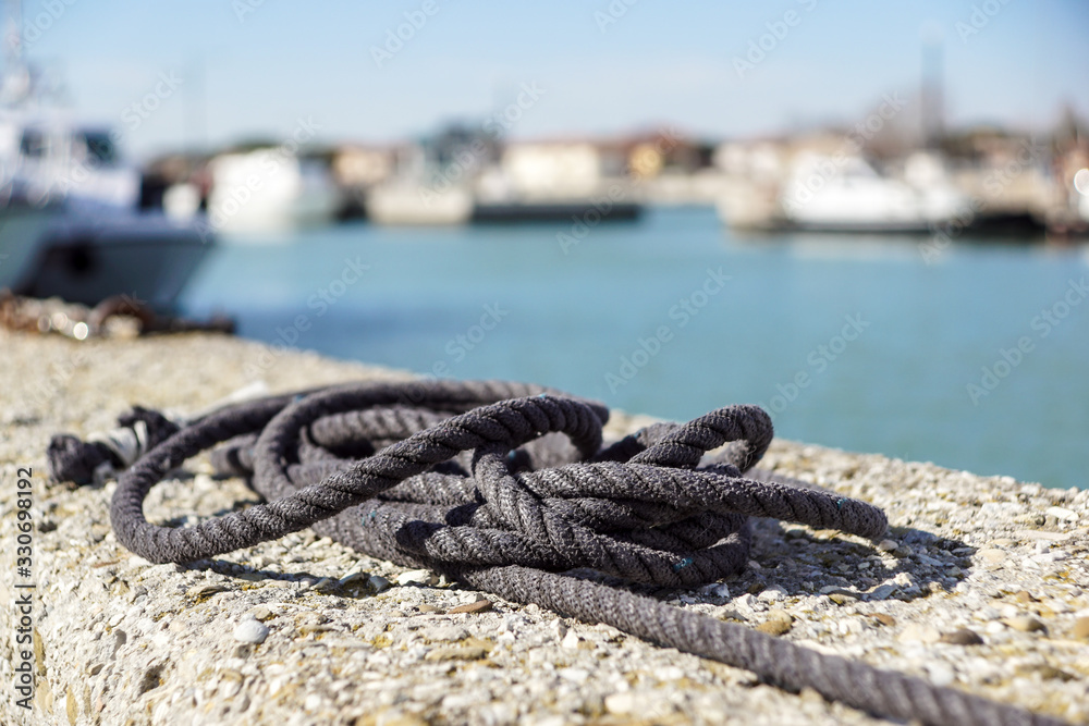 A white sailing rope on a wharf pier