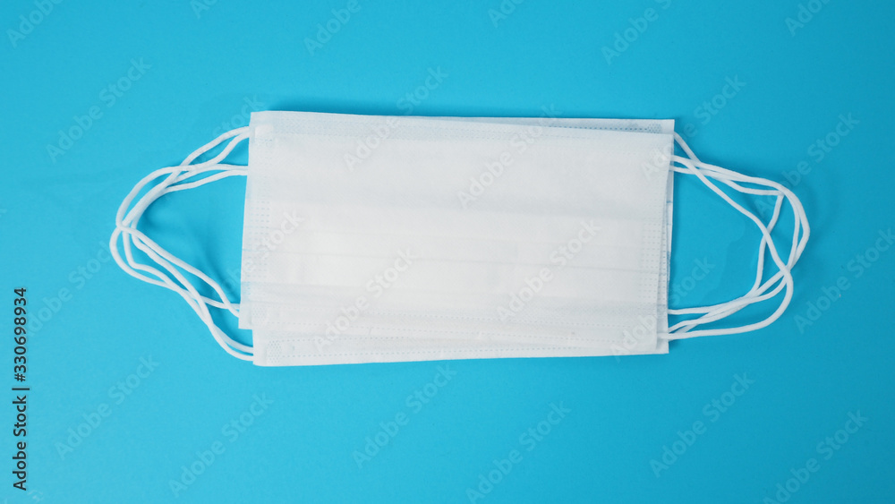 Disposable Ear- loop face mask on blue background. Disposable Ear- loop face mask on blue background.