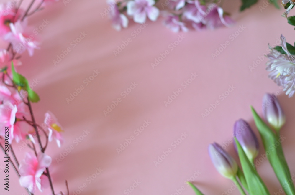 purple and lilac flowers and tulips on a pink background. spring, summer concept, background for cards and cosmetics