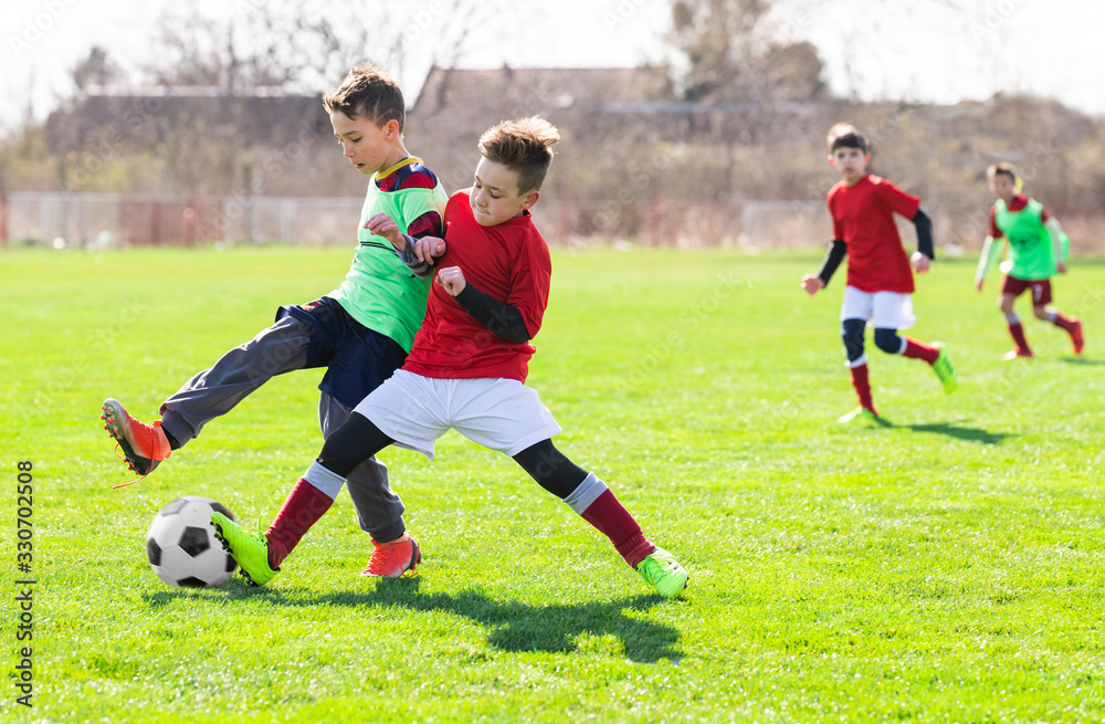 Boys play soccer sports field