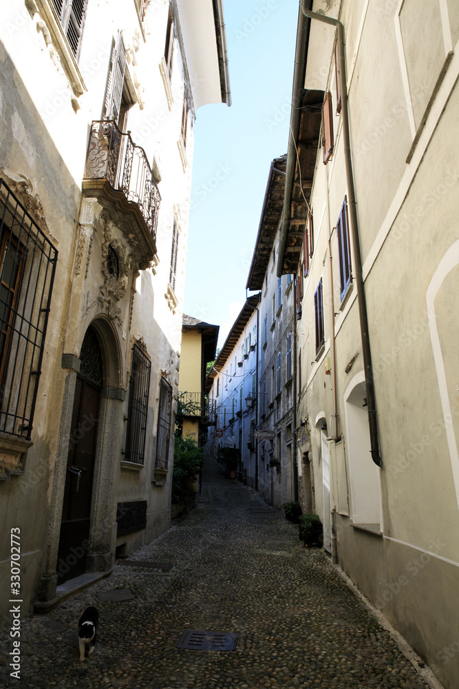 Naklejka premium Orta San Giulio (NO), Italy - September 02, 2019: A typical small road in Orta San Giulio island, Orta, Novara, Piedmont, Italy