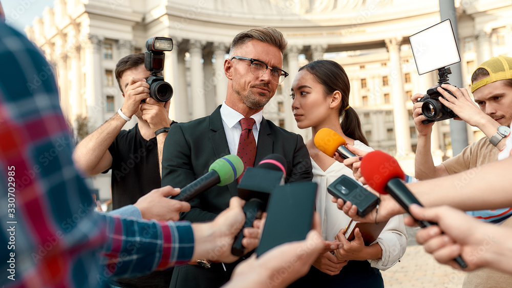 Fototapeta premium Have you ever wished you were better informed. Journalists conducting interview of politician. Journalism industry, live streaming concept.
