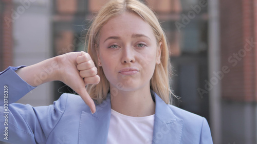 Thumbs Down by Young Businesswoman, Outdoor