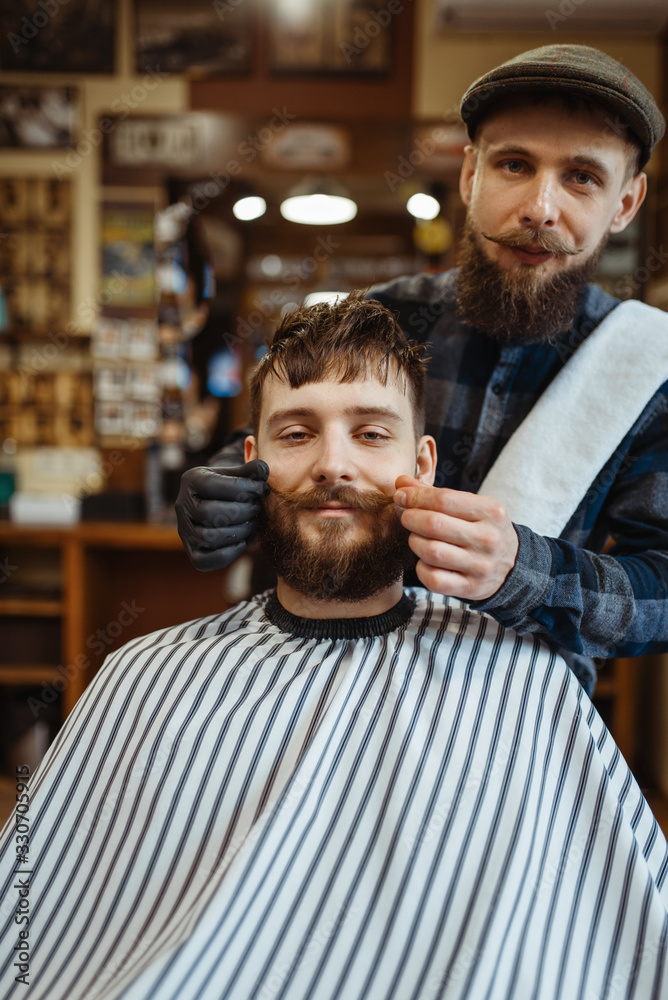 Barber and customer with a mustache, barbershop Barber and customer with a mustache, barbershop