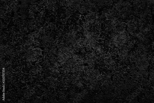 Abstract black background. Black stucco texture. Dark rough surface.