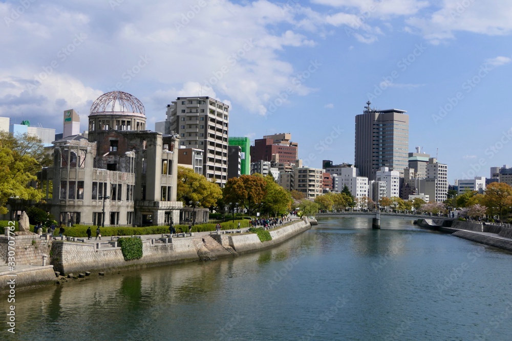 Atomic bomb dome before river with skyline, Hiroshima, Japan