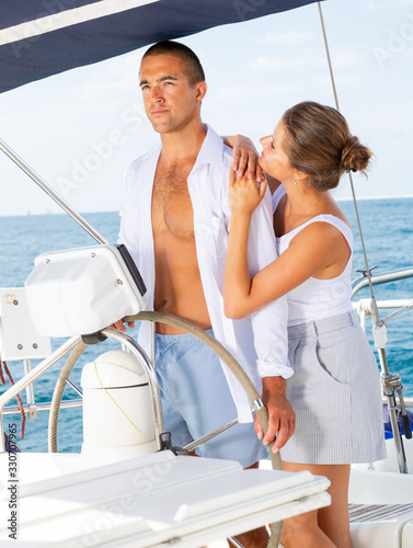 Man and woman steering pleasure yacht © JackF