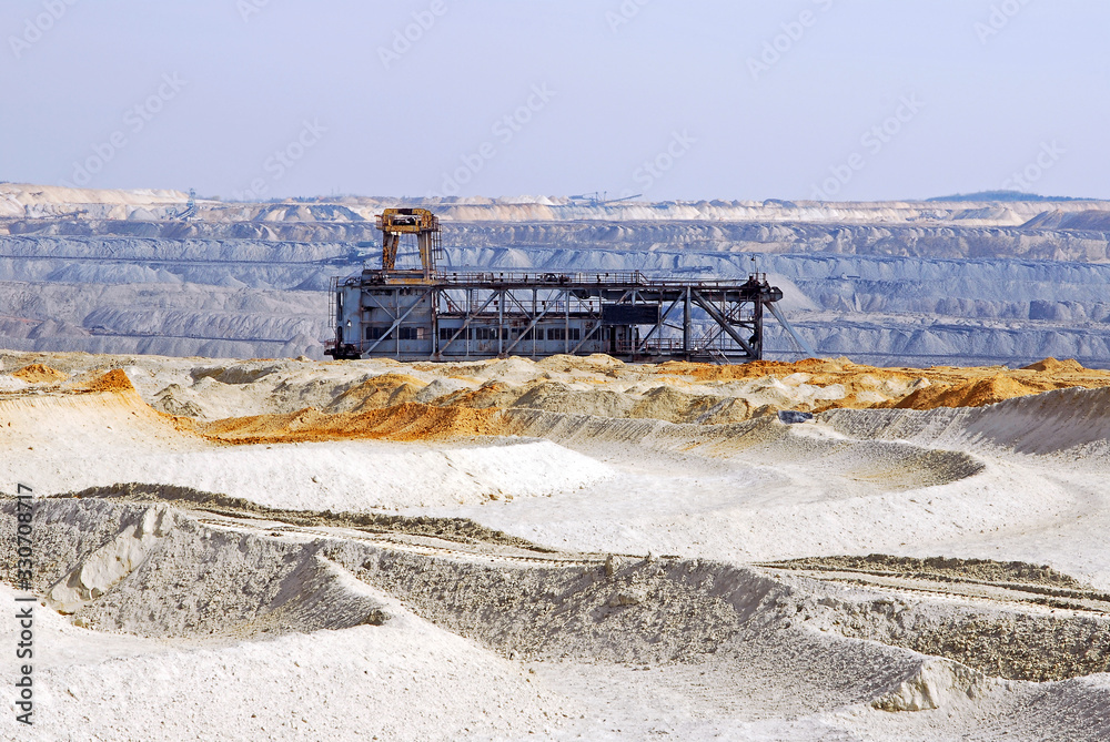 Fototapeta premium Sand dunes made by excavator. An interesting sight from a coal mine. Beautiful geological structures on open pit coal mine. 