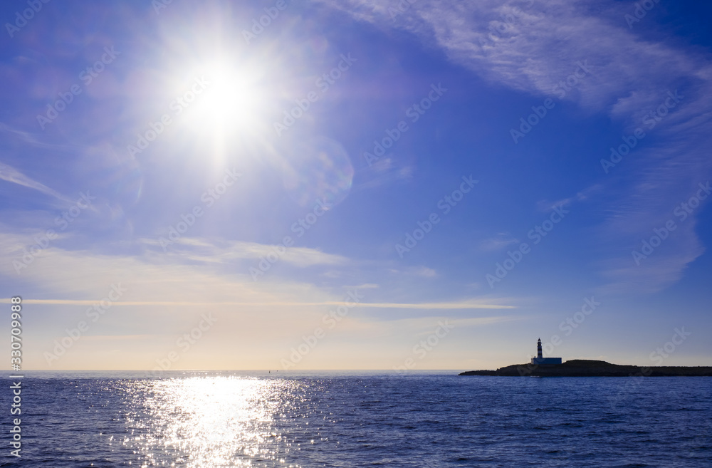 Lighthouse before Ibiza island Ibiza city sun sky soft colours beautiful view sailing ferryboat vacation .