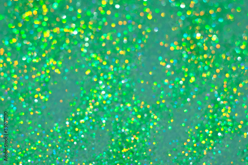Thousand bokeh blur green sparkles. Perfect St.Patrick's Day background for your design.