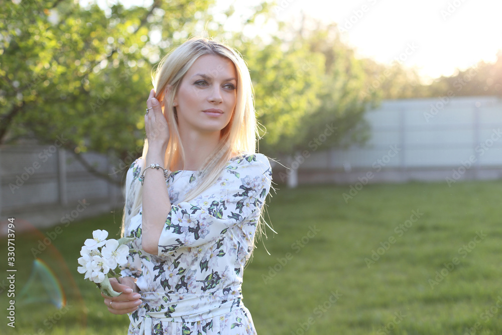 horizontal portrait of a stunningly beautiful blonde in a white dress with flowers horizontal portrait of a stunningly beautiful blonde in a white dress with flowers
