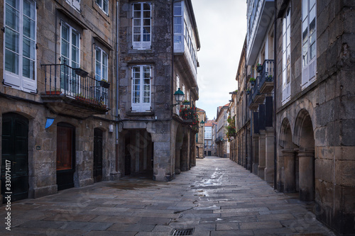 Pedestrian street and historic building facades in old town Santiago de Compostela, Spain. © jarcosa