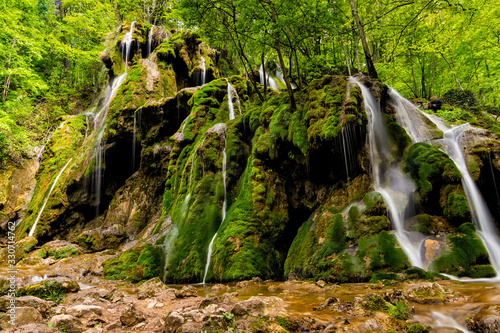 Fototapeta Naklejka Na Ścianę i Meble -  Beautiful Beusnita waterfall in the forest with green moss, Caras Severin county, National Park, Cheile Nerei, Bozovici, Romania