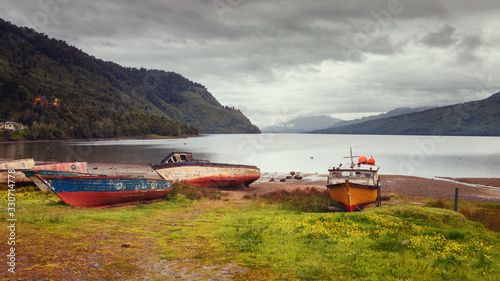 Fishing boats on the beach of Puyuhuapi Fjord, Patagonia, Chile, Pacific Ocean photo