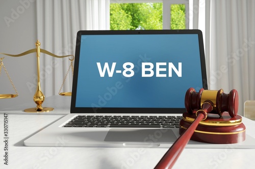 W-8 BEN – Law, Judgment, Web. Laptop in the office with term on the screen. Hammer, Libra, Lawyer. photo