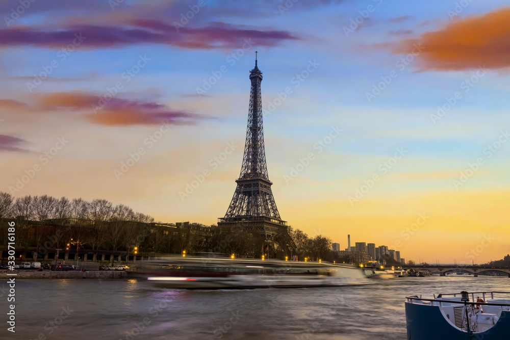 Eiffel tower and Seine river in the sunset sky scene.