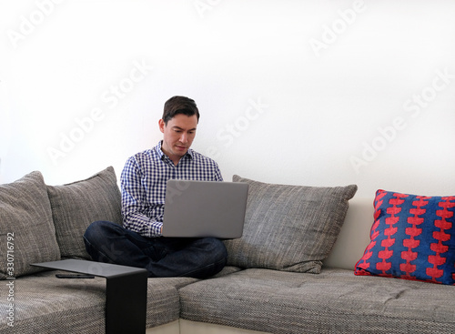 Man working from home with a laptop in the living room