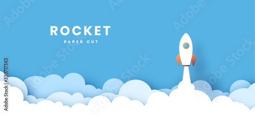 rocket illustration flying over cloud. beautiful scenery with white clouds. paper cut. startup concept vector photo
