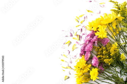bouquet of yellow and violet spring flowers isolated on white background. Top view. Copy space