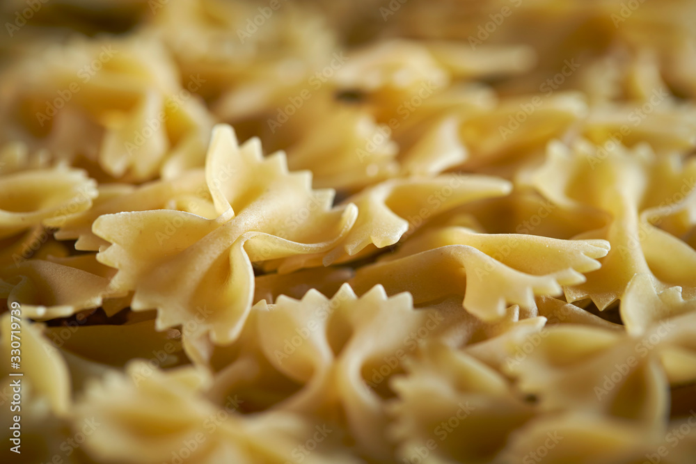 Dried farfalle short pasta background Dried farfalle short pasta background