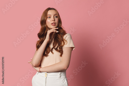 young casual style woman posing isolated on pink background