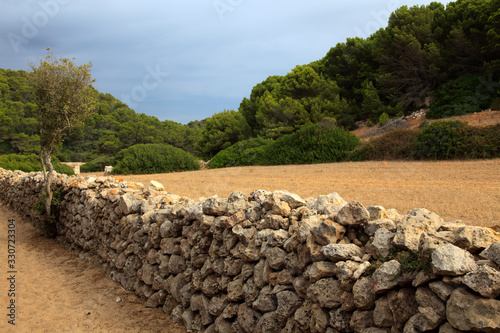 Sant Tomas, Menorca / Spain - June 25, 2016: A dry rock wall near Binigaus beach, Sant Tomas, Menorca, Balearic Islands, Spain