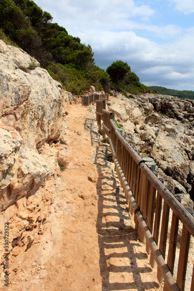 Es Migjorn Gran, Menorca / Spain - June 25, 2016: The trail to Escorxada beach, Es Migjorn Gran, Menorca, Balearic Islands, Spain