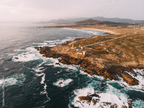 Aerial view of rocky coastline and Lighthouse at sunset in north photo