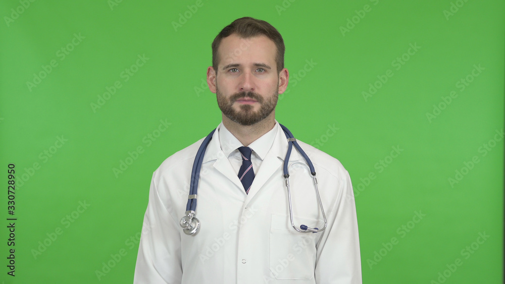 The Handsome Doctor looking at Camera against Chroma Key