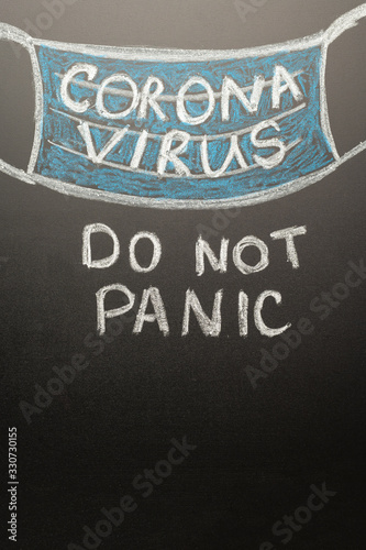 A drawn mask on a board with the inscription coronavirus. Headline in the news, articles. Epidemic and pandemic, problemma in medetsine, lack of masks, the inscription DO NOT PANIC!