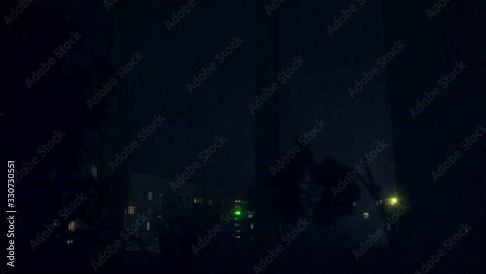 Thunder lightning over a residential building window view