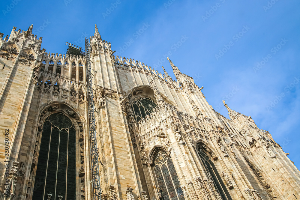Side view of the wall of Milan Cathedral with spires