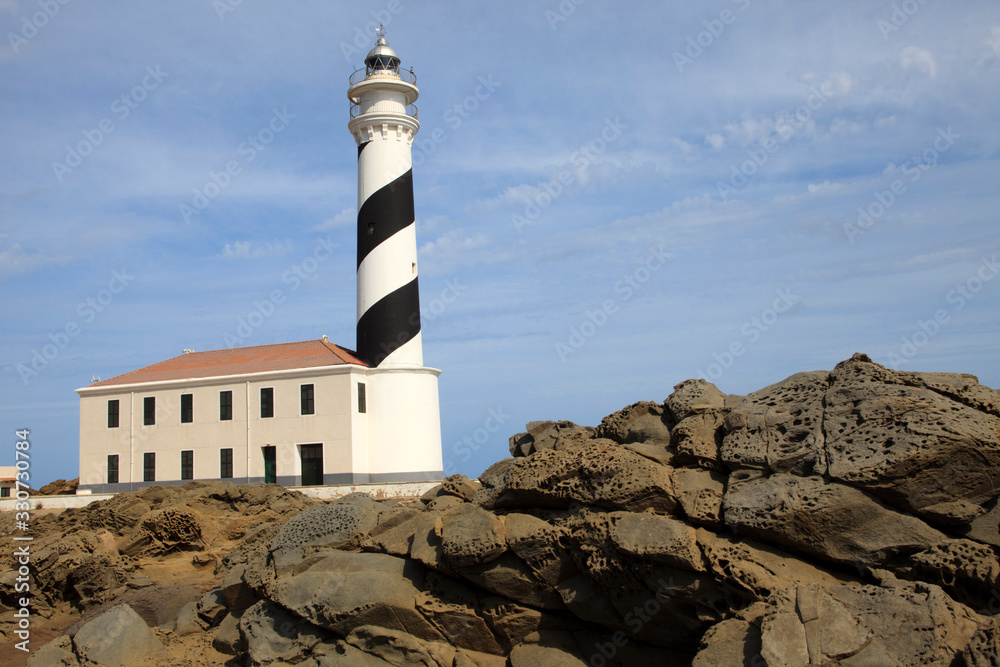 Fototapeta premium Cape Favaritx, Menorca / Spain - June 23, 2016: The lighthouse at Cape Favaritx, Menorca, Balearic Islands, Spain