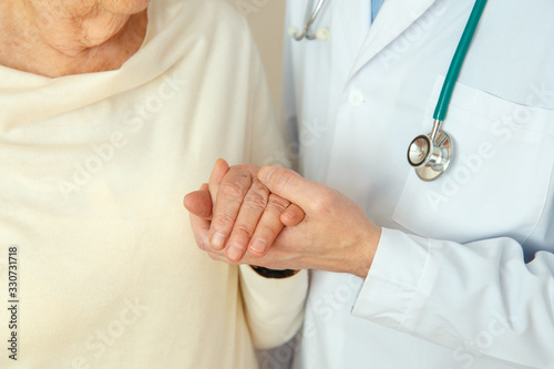 Helping hands, elderly care concept, Doctor's hand holds a woman's hand